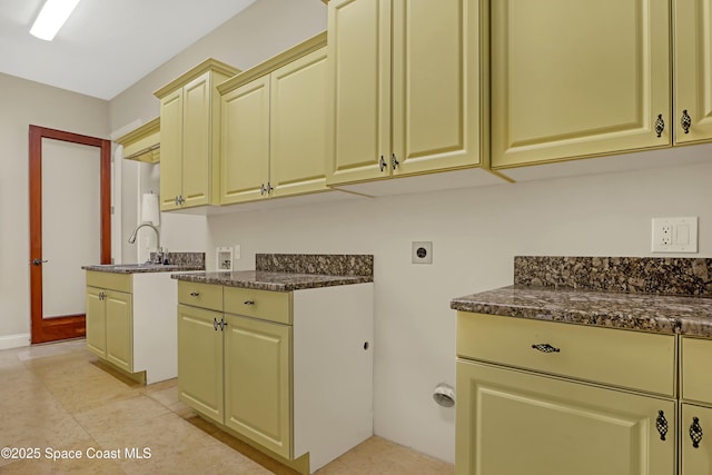 laundry area featuring sink, cabinets, hookup for a washing machine, and hookup for an electric dryer