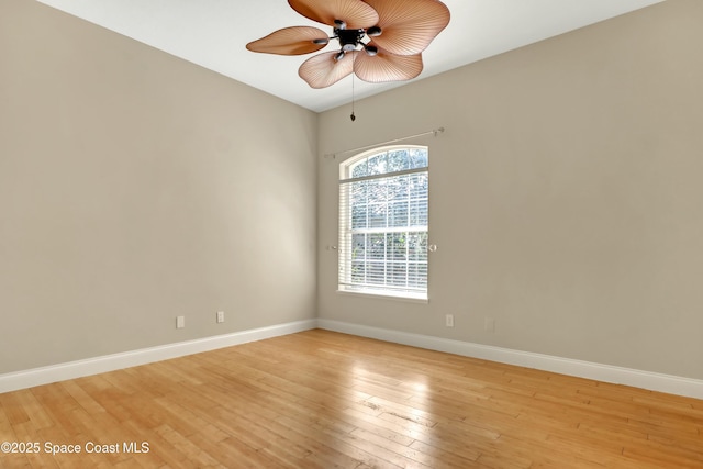 empty room with ceiling fan and light wood-type flooring