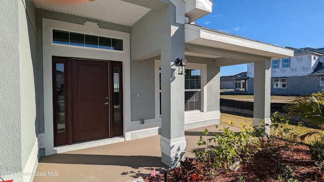 doorway to property with covered porch