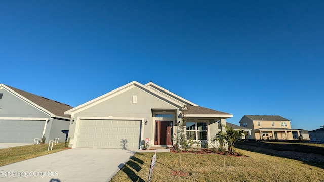 view of front of property featuring a garage and a front yard