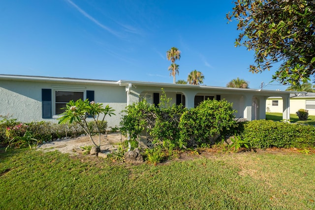 ranch-style home with a front lawn