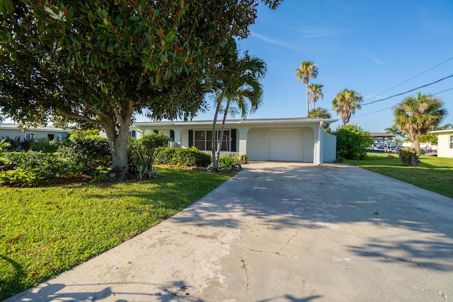 ranch-style home featuring a garage and a front lawn