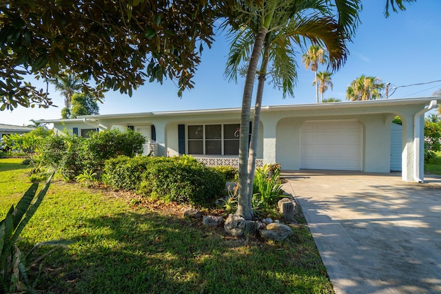 ranch-style home featuring a garage and a front lawn