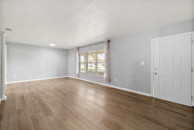 spare room featuring hardwood / wood-style floors