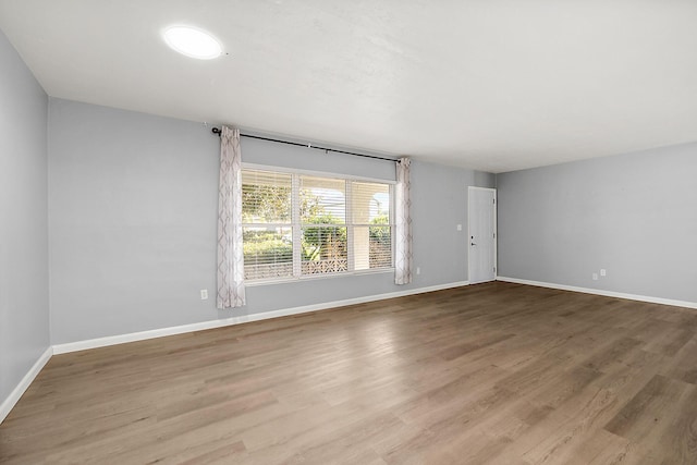 spare room featuring wood-type flooring