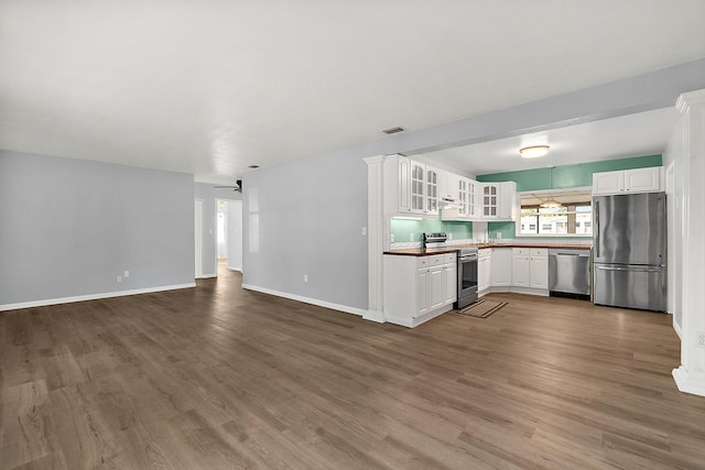 kitchen with white cabinetry, hardwood / wood-style floors, ceiling fan, and appliances with stainless steel finishes