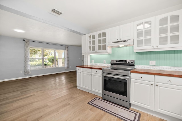 kitchen featuring wood counters, stainless steel electric stove, light hardwood / wood-style flooring, and white cabinets