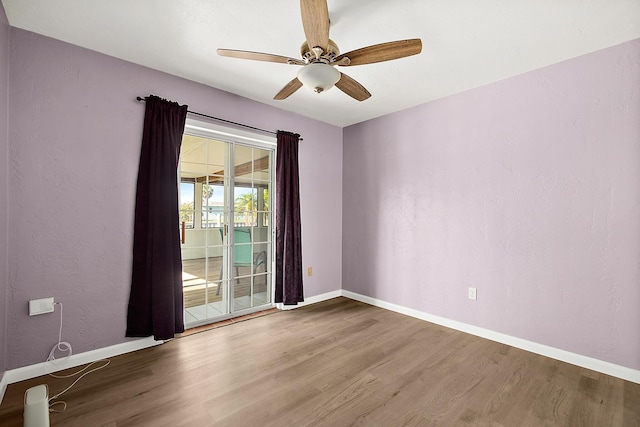 unfurnished room with ceiling fan and hardwood / wood-style floors