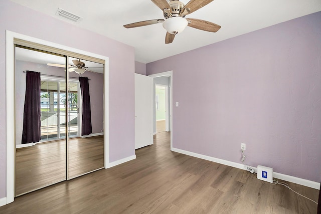 unfurnished bedroom with ceiling fan, hardwood / wood-style floors, and a closet