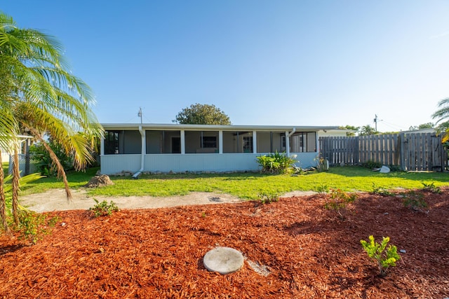 ranch-style house with a sunroom and a front yard