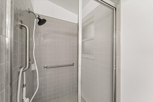 bathroom with a shower with door