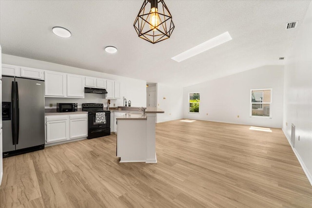 kitchen featuring black appliances, white cabinets, vaulted ceiling, light wood-type flooring, and decorative light fixtures