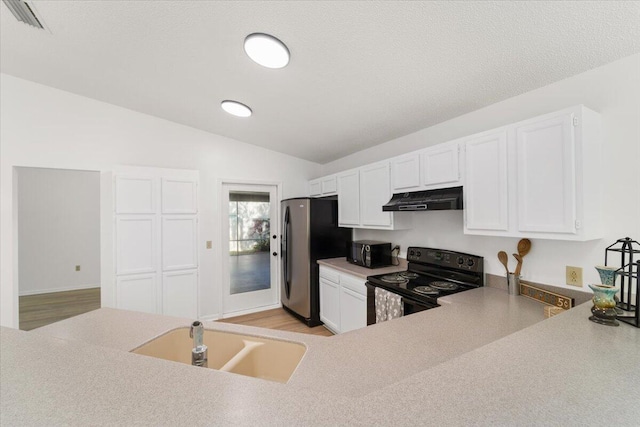 kitchen with sink, white cabinets, black appliances, and lofted ceiling