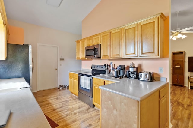 1632 Cains Ave NW, Palm Bay, FL 32907 - kitchen with a ceiling fan, light wood finished floors, appliances with stainless steel finishes, and light brown cabinetry