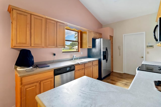 1632 Cains Ave NW, Palm Bay, FL 32907 - kitchen with a sink, light countertops, light wood finished floors, lofted ceiling, and stainless steel appliances