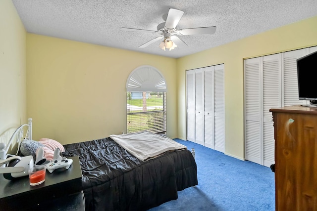 1632 Cains Ave NW, Palm Bay, FL 32907 - bedroom featuring multiple closets, ceiling fan, carpet, and a textured ceiling