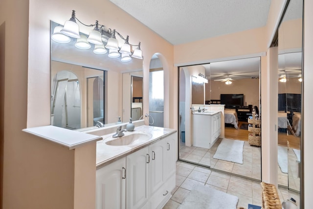 1632 Cains Ave NW, Palm Bay, FL 32907 - full bathroom with tile patterned flooring, vanity, ensuite bath, a textured ceiling, and a ceiling fan