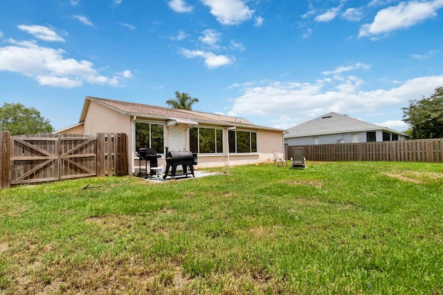 1632 Cains Ave NW, Palm Bay, FL 32907 - rear view of house with a gate, stucco siding, and a fenced backyard