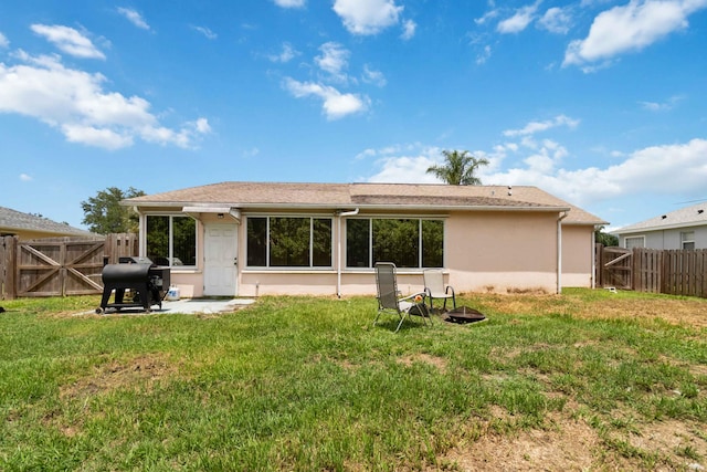 rear view of house featuring a patio area and a lawn