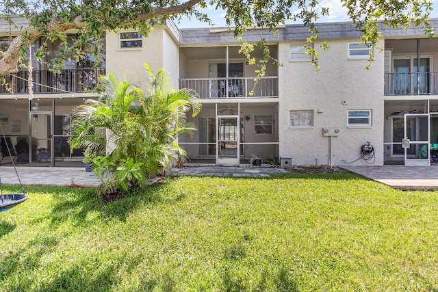 rear view of property featuring a patio area and a yard