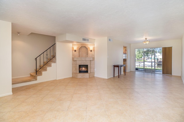 unfurnished living room featuring a fireplace and light tile patterned floors