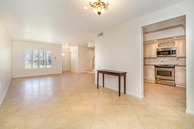 interior space with light tile patterned floors and an inviting chandelier