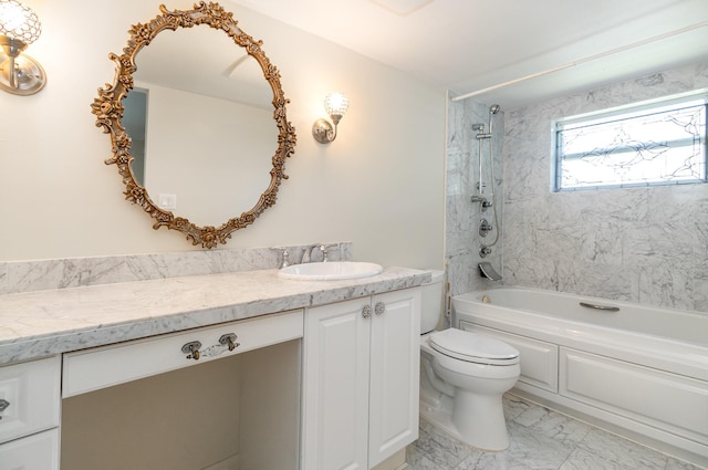 full bathroom with toilet, vanity, and tiled shower / bath