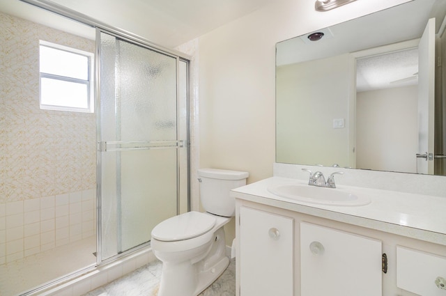 bathroom with vanity, toilet, and walk in shower