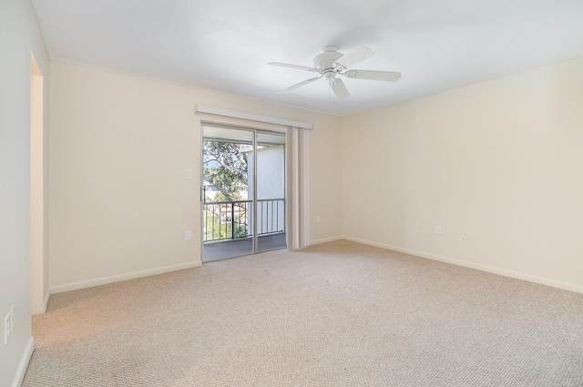 empty room featuring ceiling fan and light carpet