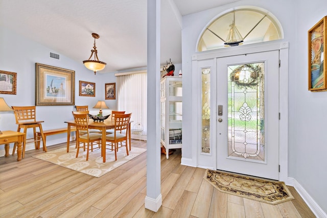 foyer entrance featuring light hardwood / wood-style floors and lofted ceiling