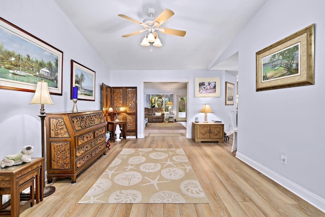 interior space with light wood-type flooring and vaulted ceiling