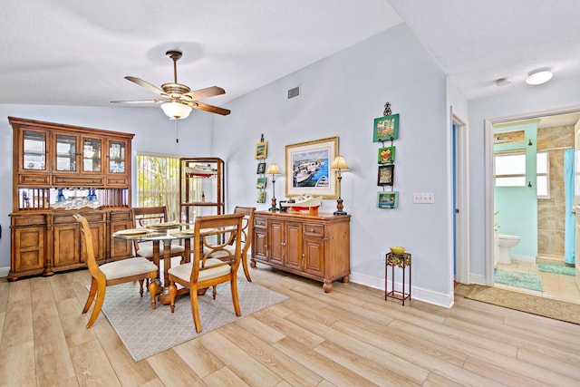 dining area featuring ceiling fan, light hardwood / wood-style flooring, and lofted ceiling