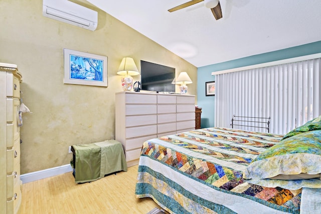 bedroom with an AC wall unit, hardwood / wood-style floors, lofted ceiling, and ceiling fan