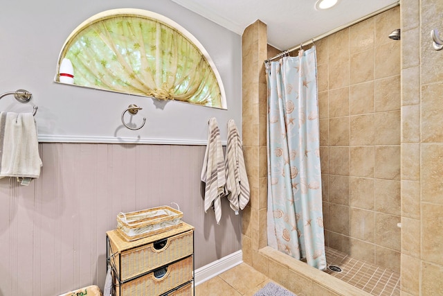 bathroom with crown molding, a shower with shower curtain, and tile patterned flooring