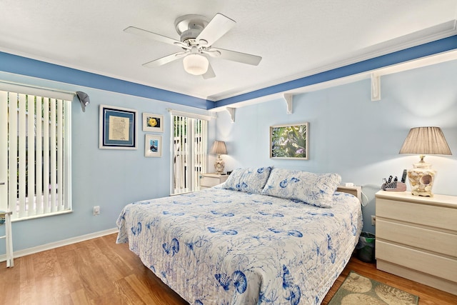 bedroom featuring crown molding, hardwood / wood-style floors, and ceiling fan