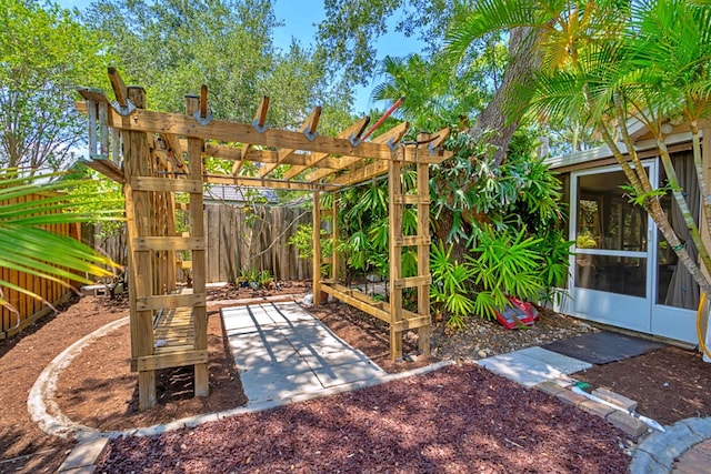 view of patio / terrace with a sunroom and a pergola