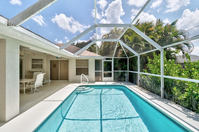 view of swimming pool with a lanai and a patio