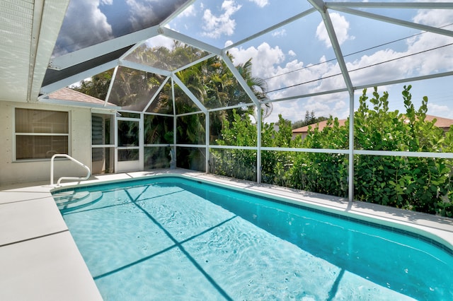 view of swimming pool with glass enclosure