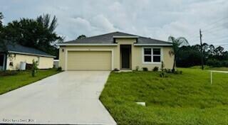 view of front of house featuring a garage and a front lawn