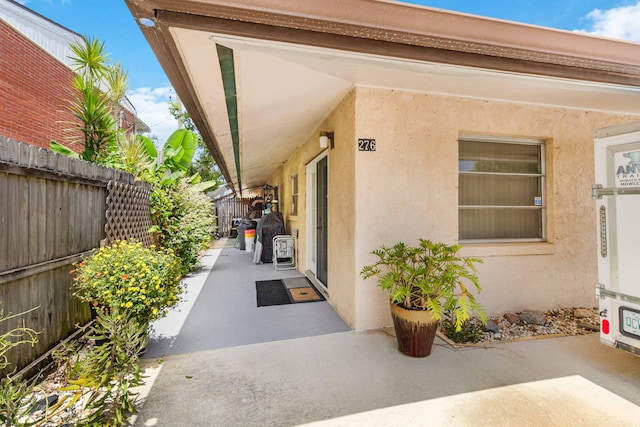 view of exterior entry with a patio