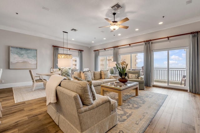 living room featuring ceiling fan, crown molding, and wood-type flooring