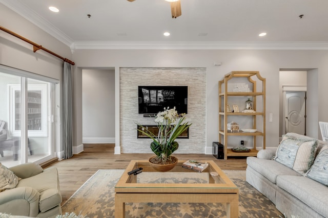 living room with crown molding, hardwood / wood-style flooring, and ceiling fan