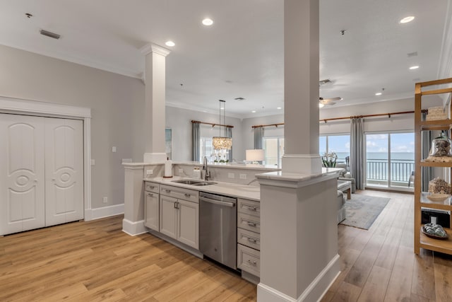 kitchen featuring light hardwood / wood-style flooring, kitchen peninsula, dishwasher, hanging light fixtures, and sink