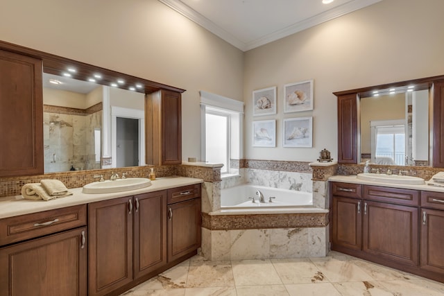 bathroom with a relaxing tiled bath, vanity with extensive cabinet space, tile flooring, and a wealth of natural light