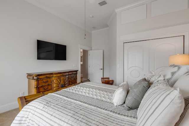carpeted bedroom featuring crown molding and a closet