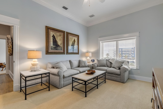 carpeted living room with crown molding and ceiling fan