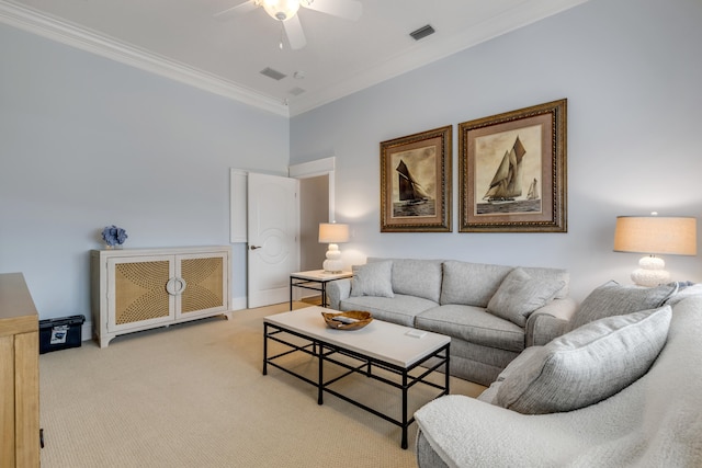 carpeted living room with ceiling fan and ornamental molding