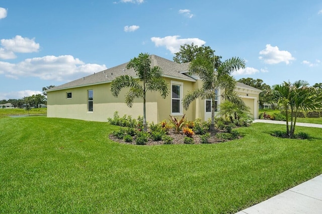 view of home's exterior featuring driveway, a lawn, an attached garage, and stucco siding