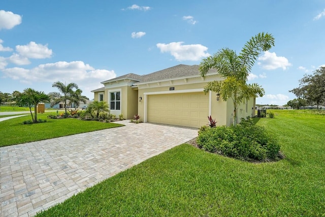 view of front of home featuring a front yard, decorative driveway, an attached garage, and stucco siding