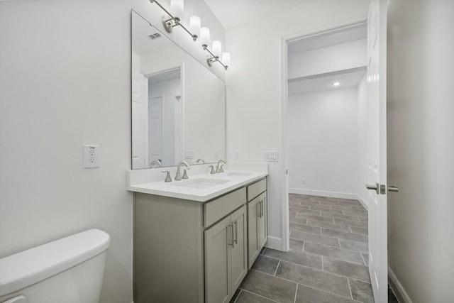 bathroom featuring vanity, tile patterned flooring, and toilet